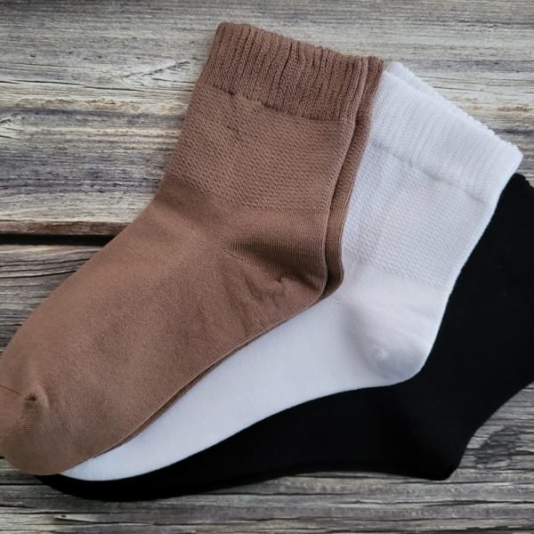 three pairs of socks on table