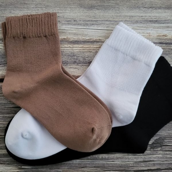 three pairs of socks on table